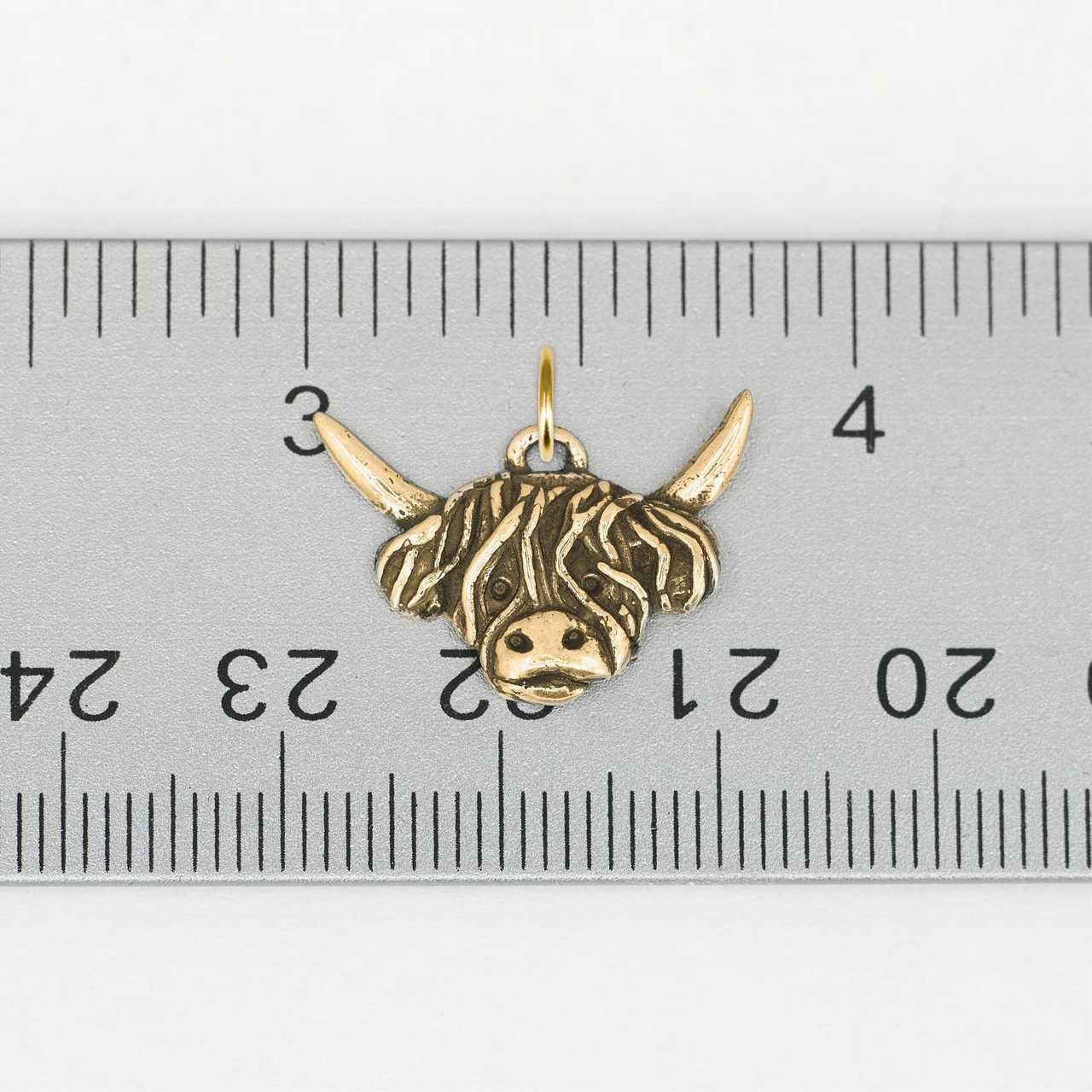 https://cdn11.bigcommerce.com/s-fhmvcm10bs/images/stencil/1280x1280/products/2403/8872/gold_highland_cow_charm_on_ruler__81603.1662480847.jpg?c=1