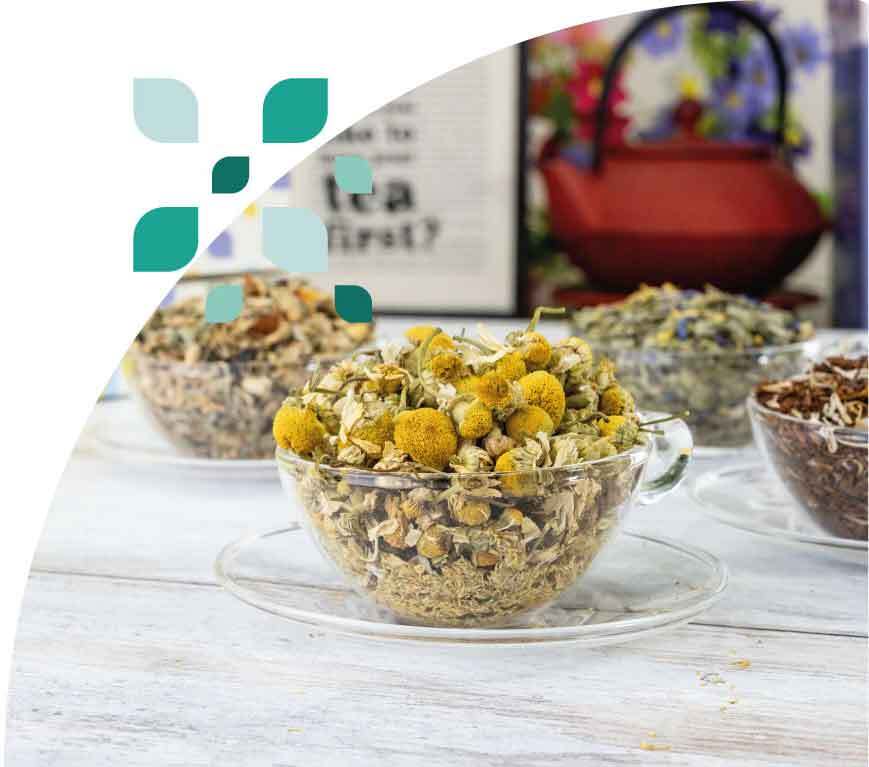 A beautifully presented glass cup of premium wholesale chamomile tea flowers from Jenier.