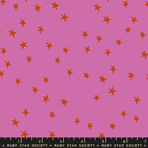 Moda Fabrics Starry Ruby Star Society Heliotrope Purple Stars fabric, purple background with scattered orange star patterns.