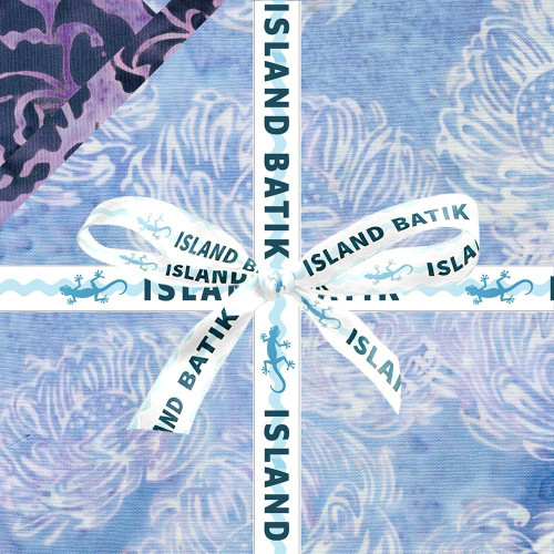 Lumin Fabrics Island Batik Rosy Bloom Batiks 5 Inch Squares, beautifully wrapped with a white ribbon featuring blue gecko and island batik text on a pastel blue background.