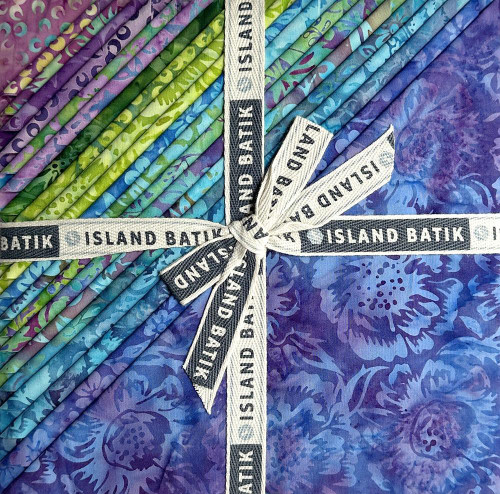 Lumin Fabrics Island Batik Springtime Bouquet Batiks 10 Inch Squares, colorful fabric squares with floral patterns in shades of purple, blue, green, and teal, tied with a white ribbon labeled 'Island Batik'.