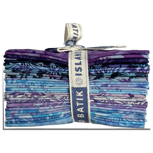 Lumin Fabrics Island Batik Secret Garden Batiks Fat Quarter Bundles, colorful fabric bundle with various purple and blue batik fabric pieces.