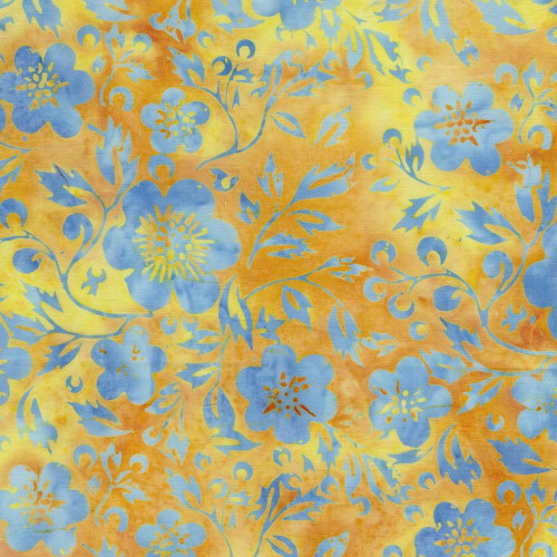 Lumin Fabrics Island Batik Countryside Charm Batiks Flowers and Leaves Yellow Amber, fabric with blue floral and leaf pattern on a yellow and orange background.