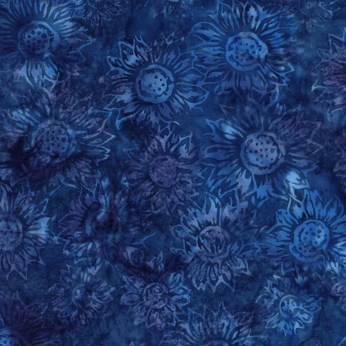 Lumin Fabrics Island Batik Sunflower Spice Batiks Medium Sunflowers Blue Blueberry, a textile with a pattern of medium-sized sunflower motifs in shades of blue on a dark blue background.