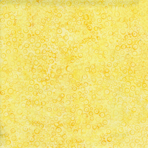 Timeless Treasures Fabrics Radiant Meadow Tonga Batiks Wing and a Prayer Dotty Bubbles Sunny, yellow fabric with a pattern of small, concentric circles in varying shades of yellow.