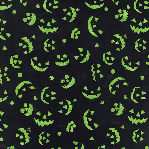 Timeless Treasures Fabrics Tonga Batiks Haunted Halloween Spooky Pumpkin Smiles Lime Green Spooky, a fabric with glowing green pumpkin faces and spooky motifs on a black background.