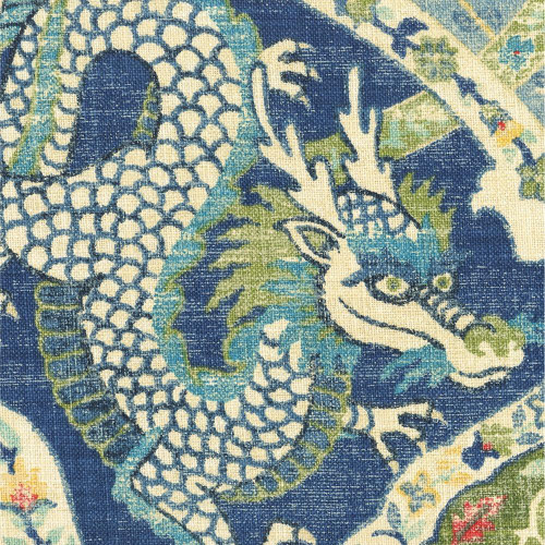 Covington Fabrics Falkor Dream Blue Happy Dragon Medallions, close-up of a vibrant dragon pattern on fabric featuring blue, green, and white colors.