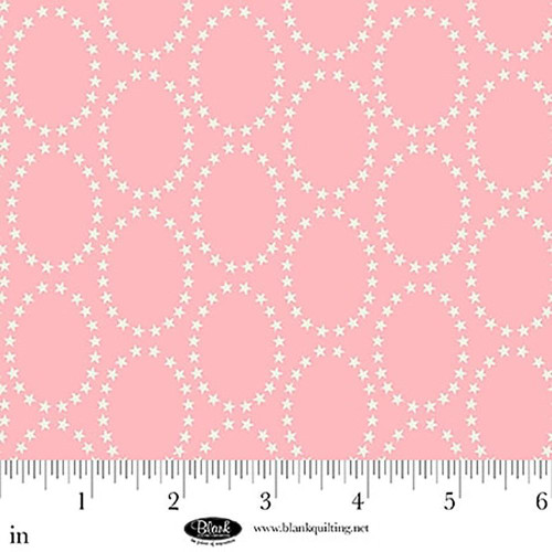 Blank Quilting Fabrics The Bright Side Jessica Dayon Light Pink Star Ovals, light pink fabric with white star oval pattern and a ruler at the bottom for scale.