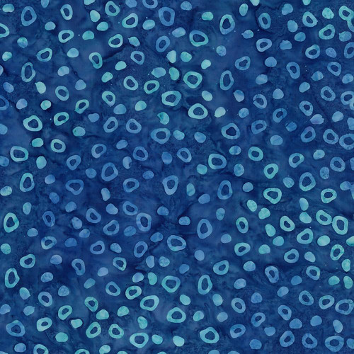 Riley Blake Fabrics Bold in Bloom Batiks Fran Morgan Royal Blue Green Fruitty Pebbles, close-up of fabric with blue background and scattered light blue and green circular motifs.