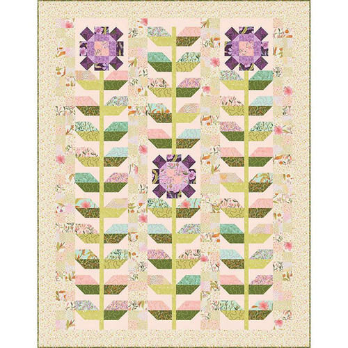 Maisy Daisies Quilt Pattern by Moda Floral Fondant Fabrics, colorful quilt featuring floral and leaf motifs with pink, purple, green, and pastel shades in a floral design.
