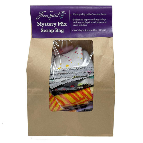 FreeSpirit Fabrics Mystery Scrap Bag, collection of colorful fabric scraps with various patterns inside a brown paper bag with a purple top label.