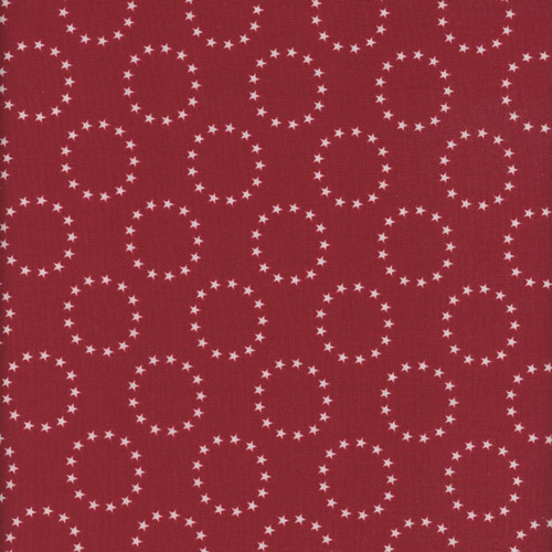 Riley Blake Fabrics Independence 13 Colonies Ring of Stars Red Cherry, close-up of red fabric with white star pattern forming circular arrangements.