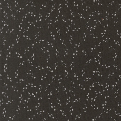 Moda Fabrics The Henhouse Gingiber Iron Grey Chicken Feet, dark grey fabric with white chicken footprint pattern.