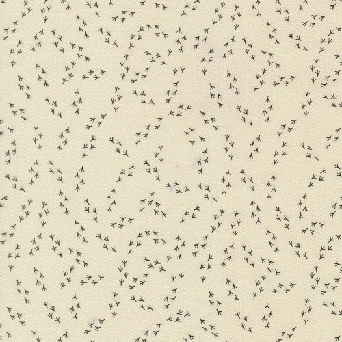 Moda Fabrics The Henhouse Gingiber Cloud Cream Iron Grey Chicken Feet fabric, featuring a pattern of small black chicken footprints on a cream background.