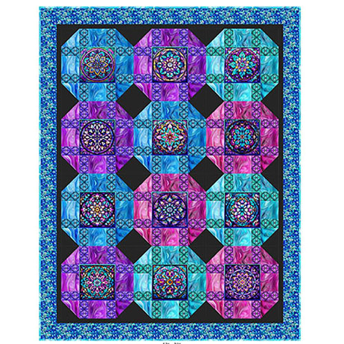 Quilting Treasures Fabrics Royale Dan Morris Posh Patchwork Quilt Kit, colorful quilt with intricate geometric and floral patterns in blue, purple, pink, and black colors with a decorative border.