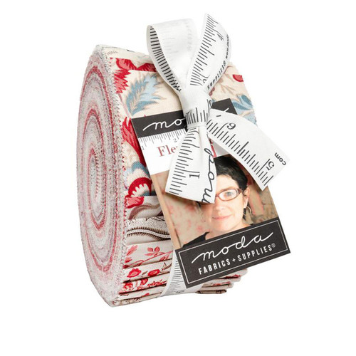 Moda Fabrics Fleur De Paris French General Jelly Roll Fabric Strips, colorful floral and pattern fabric strips rolled and tied with a measuring tape ribbon.