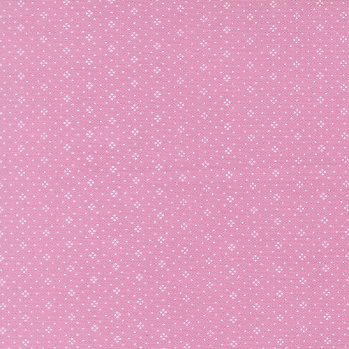 Moda Fabrics Summers End Fig Tree Co Lilac Pink Eyelet Basics, close-up of pink fabric with small white eyelet floral pattern.