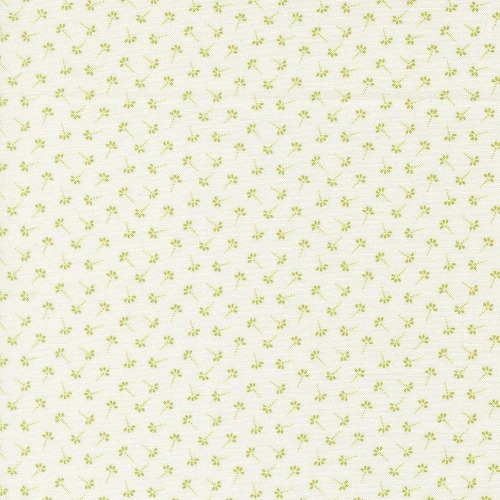 Moda Fabrics Summers End Fig Tree Co Clover Green Dandelion Wisps, a light-colored fabric featuring small, green, floral and leaf patterns.