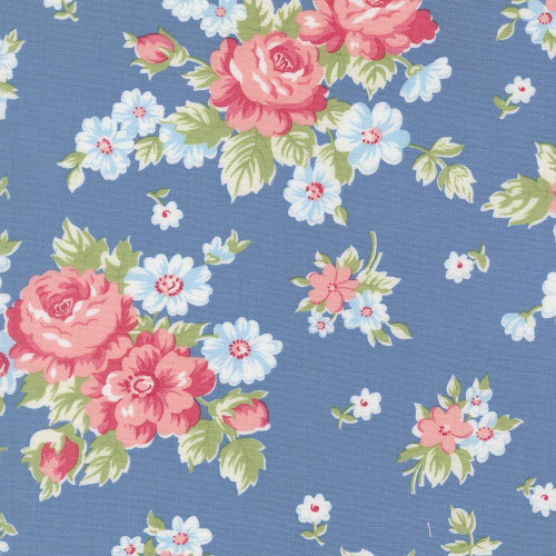 Moda Fabrics A Cat Named Stitch Camille Roskelley Cabbage Rose Floral Blue, blue floral fabric with pink roses, light blue daisies, and green leaves.