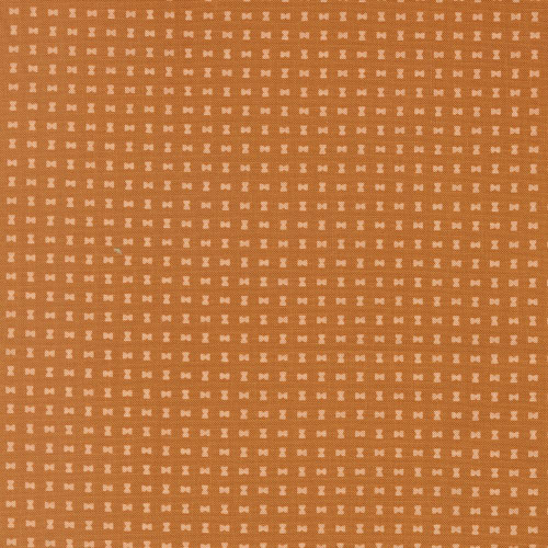 Moda Fabrics Scenery Elizabeth Hartman Spools Spools Pumpkin Orange Brown, fabric with small white spool pattern on pumpkin orange background.