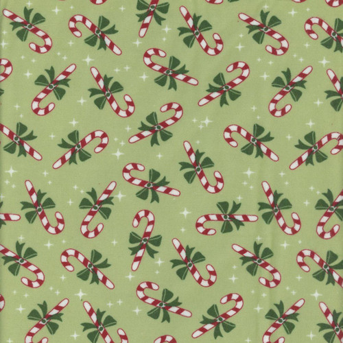 Riley Blake Fabrics The North Pole Flannel My Minds Eye Candy Cane Honeydew Green, festive Christmas holiday pattern with candy canes and holly leaves on a green background.