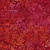 Lumin Fabrics Island Batik Posy Twist Batiks Vines Leaves and Berries Pink Rosewood, fabric with a pattern of vines, leaves, and berries in shades of pink, orange, and red.