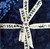 Lumin Fabrics Island Batik Countryside Charm Batiks 5 Inch Squares, navy blue fabric with floral and abstract patterns, tied with a cream-colored ribbon with blue text and lizard motif.