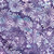 Lumin Fabrics Island Batik Secret Garden Batiks Large Daisies and Dots Purple Urchin, fabric featuring purple background with white and blue large daisy flowers and dotted details.