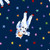 Dear Stella Fabrics Meowter Space Pammie Jane Catsa Navy Blue, fabric featuring a playful space-themed design with a cute astronaut cat lounging among colorful stars.