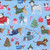 Timeless Treasures Fabrics Christmas Favorites Dogs in Christmas Sweaters Blue, fabric with festive illustrations of dogs wearing colorful Christmas sweaters, along with Christmas trees, gifts, candy canes, and holiday motifs on a light blue background.