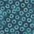Windham Fabrics Anthology Batiks Jacqueline de Jonge Luna Teal Blue Petal Wheels fabric, teal background with white petal wheel patterns.