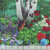 Timeless Treasures Fabrics Forest Bloom Multi Birdwood Panel 24 X 44, colorful floral fabric panel featuring vibrant flowers, green leaves, and tree trunks in a garden scene.