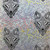 FreeSpirit Fabrics Graywork Minky Fleece by Tula Pink Wolf of Pink Street Fog, a fabric with intricate wolf face designs and floral patterns in shades of gray, black, and colorful accent leaves.