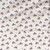 In The Beginning Fabrics Southwest Minis by Jason Yenter Grey White Cowboys Bucking Broncos fabric, featuring a pattern of galloping horses, horseshoes, and small stars on a white background.