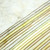 Island Batik Fabrics Foundations Naturally Neutral Batiks 2.5 inch Strip Pack, assortment of light neutral-colored fabric strips with subtle variations in cream, beige, and pale yellow shades.