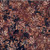 Hoffman Fabrics Bali Hand Dyed Batik Leafy Branches Ferns Fronds Walnut Brown, fabric with a pattern of leafy branches, ferns, and fronds in shades of walnut brown on a darker background.