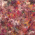 Hoffman Fabrics Bali Hand Dyed Batik Mixed Summer Flower Blooms Autumn Brown Red Purple, a vibrant fabric featuring an abstract pattern of colorful flowers and butterflies with a mix of warm autumn hues and vivid purples.
