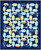 Wilmington Prints Fabrics Gentle Meadow Lola Molina Conundrum Quilt Kit, colorful quilt with geometric patterns in shades of blue, yellow, and white, featuring floral and striped prints.