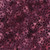 Lumin Fabrics Island Batik Cherry Blossom Large Blossoms Red Burgundy, close-up of vibrant fabric with a pattern of large cherry blossom flowers in shades of red and burgundy on a dark background, ideal for quilting or apparel.