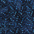Lumin Fabrics Island Batik Garden Gate Pebbles Blue Ocean, batik fabric with a dark blue background and light blue pebble-like dot pattern.