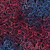 Lumin Fabrics Island Batik Paisley Parade Mini Leaf Paisley Multi Red White Blue, colorful fabric with intricate pink and purple paisley and leaf patterns on a dark background.