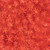 Lumin Fabrics Island Batik Starry Seas Sea Stars Orange Flame, vibrant orange batik fabric featuring starfish patterns in various sizes with a marbled background design.