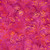 Lumin Fabrics Island Batik Hello Sunshine Long Poppies Multi Pink Yellow, vibrant fabric with a floral design featuring pink, yellow, and orange poppy flowers and leaves on a pink background.