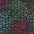 Windham Fabrics Anthology Batiks Kashmir Jacqueline de Jonge Ovals Iridescence, multicolored batik fabric with oval-shaped patterns in iridescent shades of green, blue, red, and purple on a dark background.