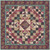 Moda Fabrics Chelsea Garden Treasure Trove Plum Quilt Kit, colorful quilt with intricate patchwork design featuring floral and paisley patterns in shades of plum, pink, and green.