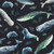Studio E Fabrics A Drop in the Ocean Cathy Walters Midnight Sealife Toss, fabric with detailed illustrations of whales, narwhals, dolphins, seals, and fish on a dark background with seaweed motifs.