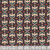 Windham Fabrics Copper Sky Kassie Kussman Onyx Black Grey Echo Flight, a fabric with a repeating pattern of stylized eagle skulls, rainbows, and lightning bolts in black, white, red, and teal colors.