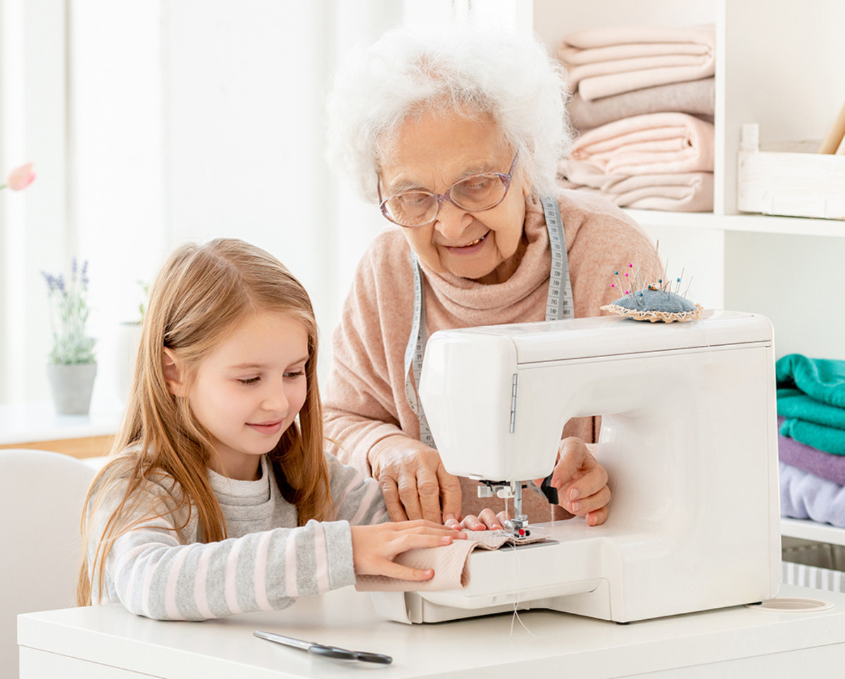 Grandmother teaching how to use a sewing machine