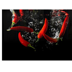 Chilli Hob Splashback, vibrant red chillies splashing into water with bubbles, on a black background.