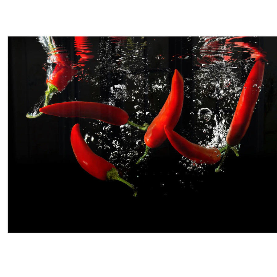 Chilli Hob Splashback, vibrant red chillies splashing into water with bubbles, on a black background.